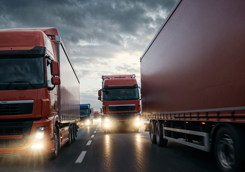 trucks-driving-highway-dusk (1)